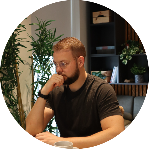 Picture of Rune Pjetursson sitting with glasses on at desk, contemplating work